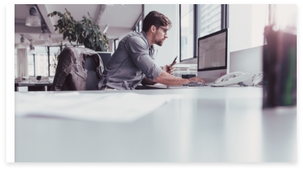 Picture of a man checking a briefing carefully on his computer screen