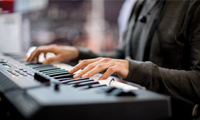 close-up of a Yamaha piano keyboard being played